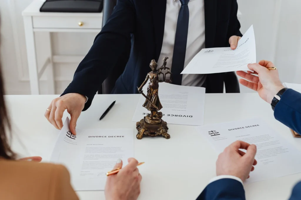 a lawyer sitting with his clients in court