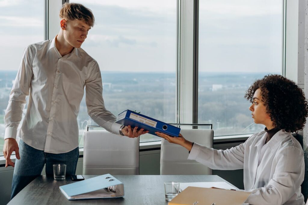 a lawyer handing sensitive documents to a private process server