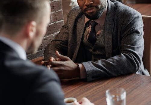 a private process server and a lawyer conversing during a meeting