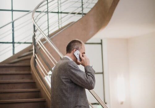 a process server talking on the phone on a staircase